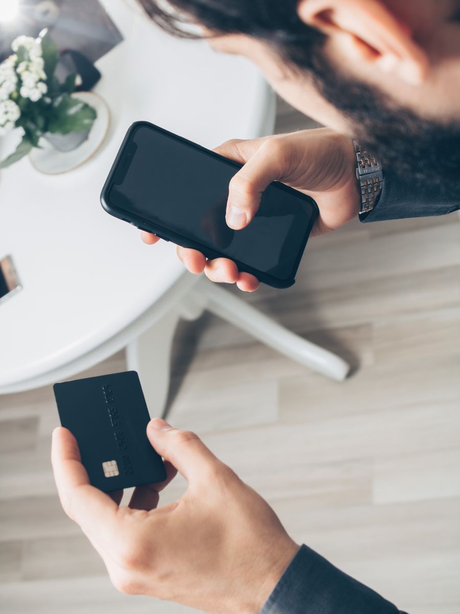 スマートフォンとクレジットカードを両手に持つ様子