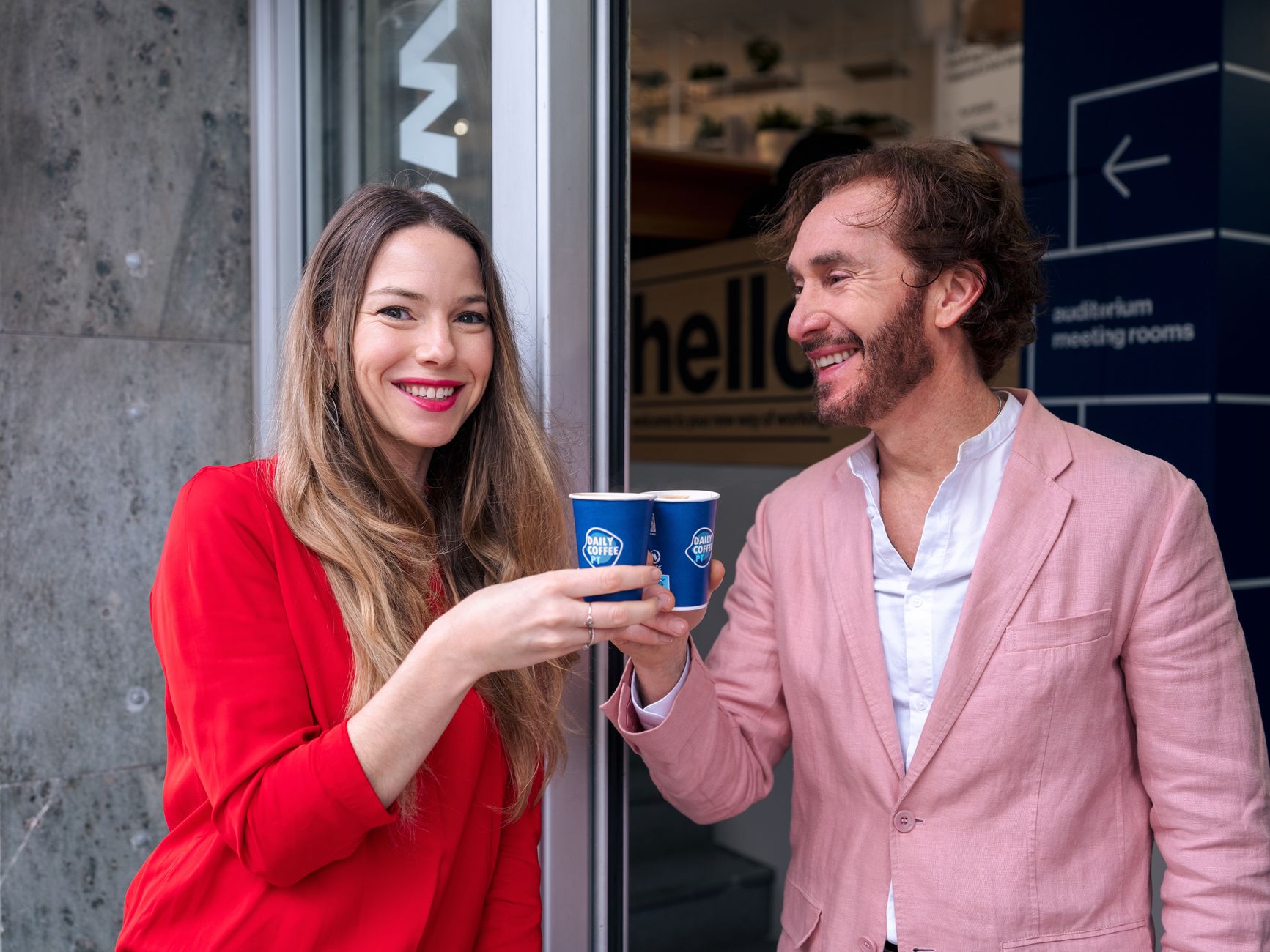 Two friends sharing a coffee moment in Lisbon, showcasing joy and friendship.